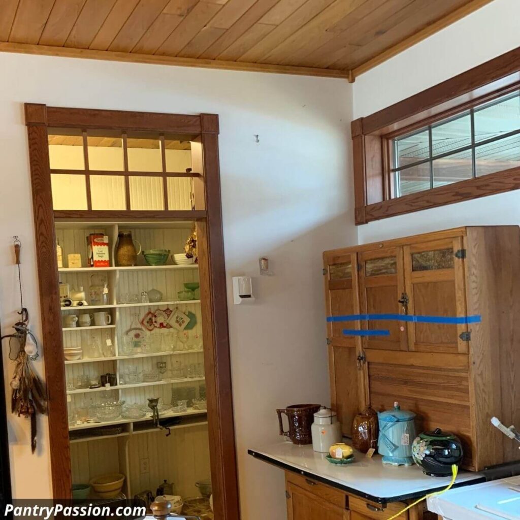 Modern "old fashioned" walk-in pantry exterior, with above door "transom-style" vent (grill) allowing air flow.