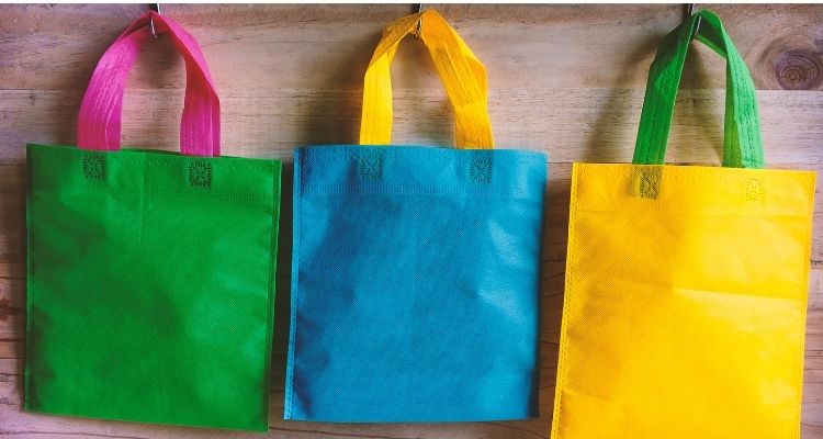 Bags hanging on wall double as food storage.
