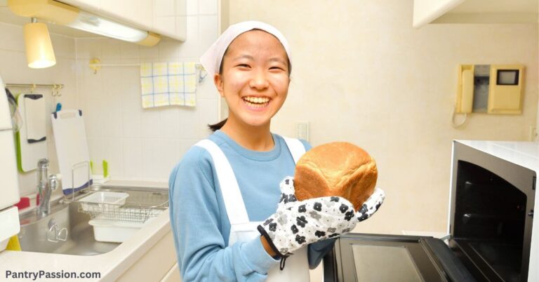 Happy girl baking bread with flour.