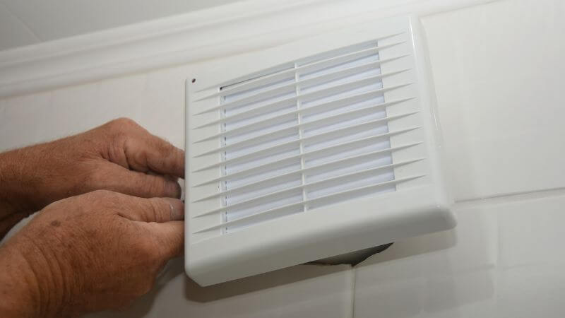 Installing a through the wall vent for air circulation.