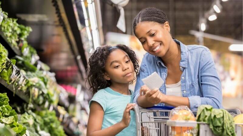 Mom and daughter grocery shopping.