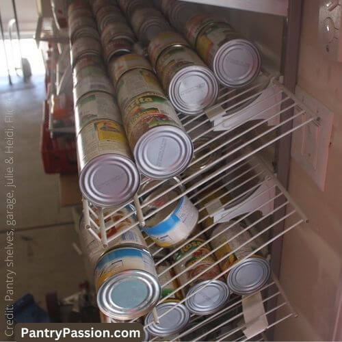 Shoe shelves used as can storage in garage.