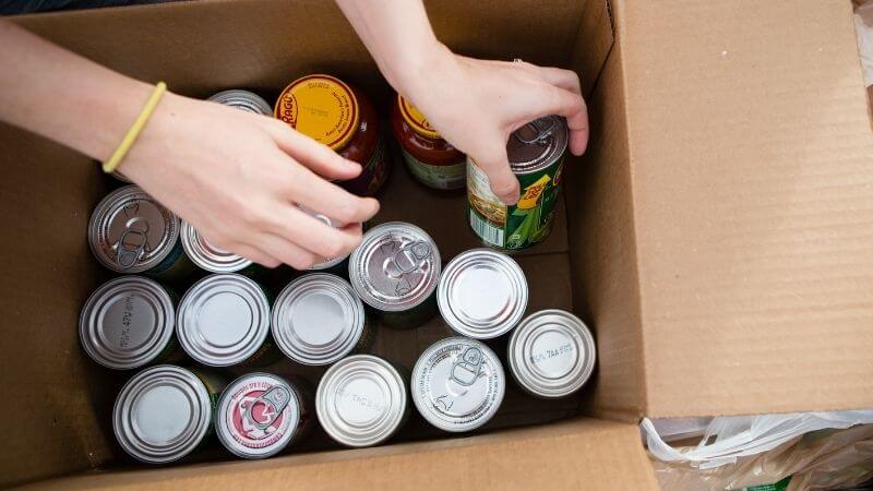 Stocking up on canned food for emergency storage.