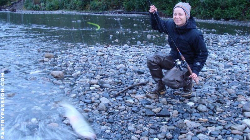 Woman salmon fishing in Alaska.