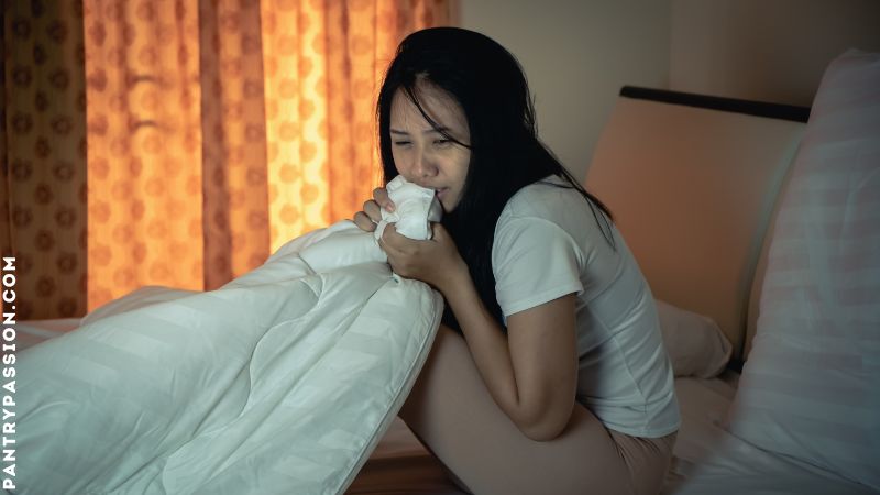 Scared woman in bed because she knows she has mice in her apartment.