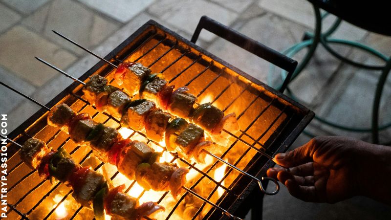 Shish kebobs on a firey bbq grill.