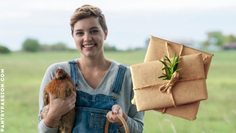 Homesteader in pasture holding a chicken.